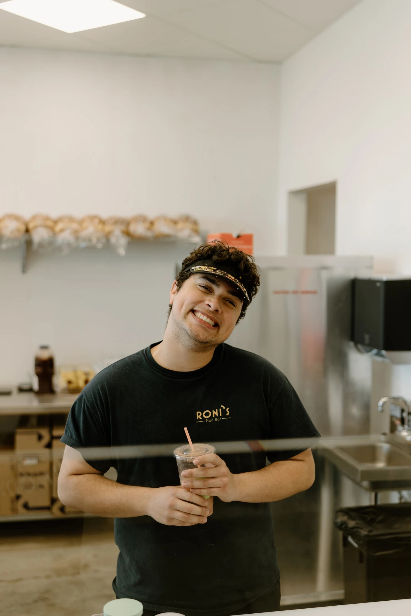 A Roni’s team member smiling behind the counter