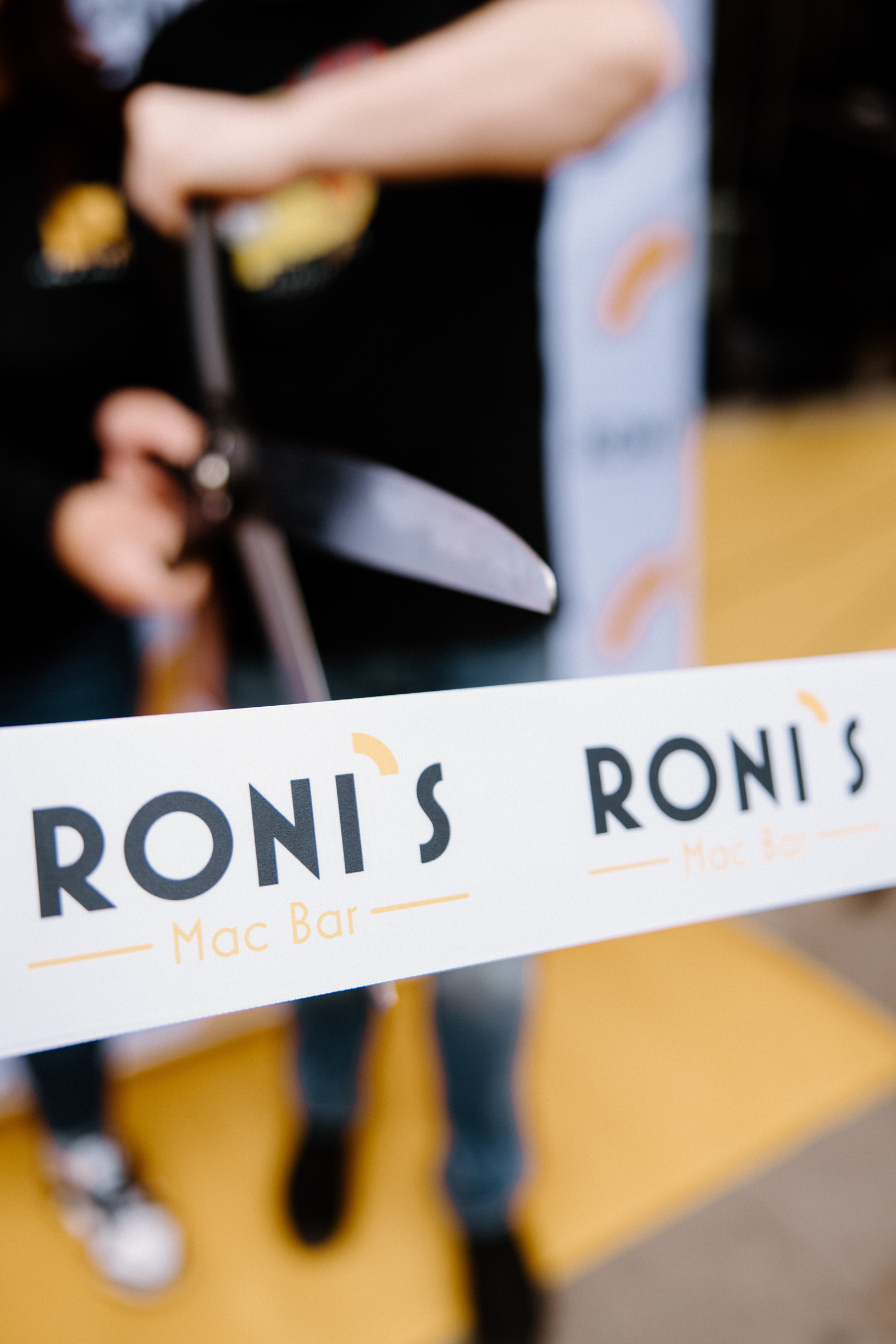 A Roni’s Mac Bar grand-opening ribbon being cut
